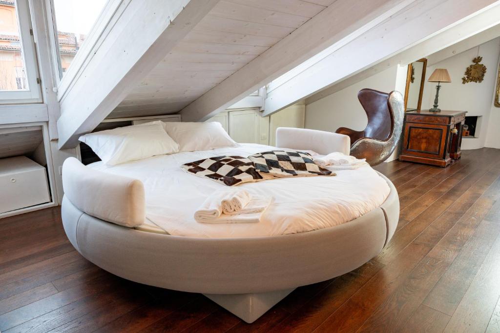 a large white bed in a room with a staircase at Al Platano Orientale in Bologna