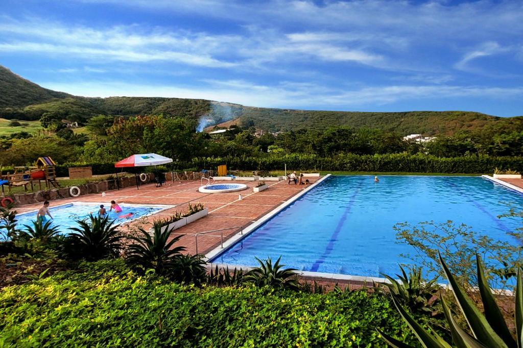 アナポイマにあるCasa de Encanto Vacacional con piscina en Anapoima, condominio privado hasta 9 personasの山を背景にした大型スイミングプール