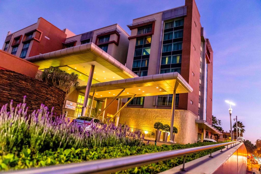 a building with lights on the side of it at Southern Sun Rosebank in Johannesburg