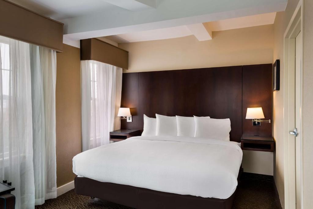 a large white bed in a hotel room at Best Western Syracuse Downtown Hotel and Suites in Syracuse