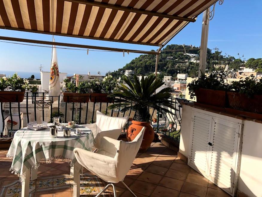 a table and chairs under an umbrella on a patio at Borgo Antico di Capri in Capri