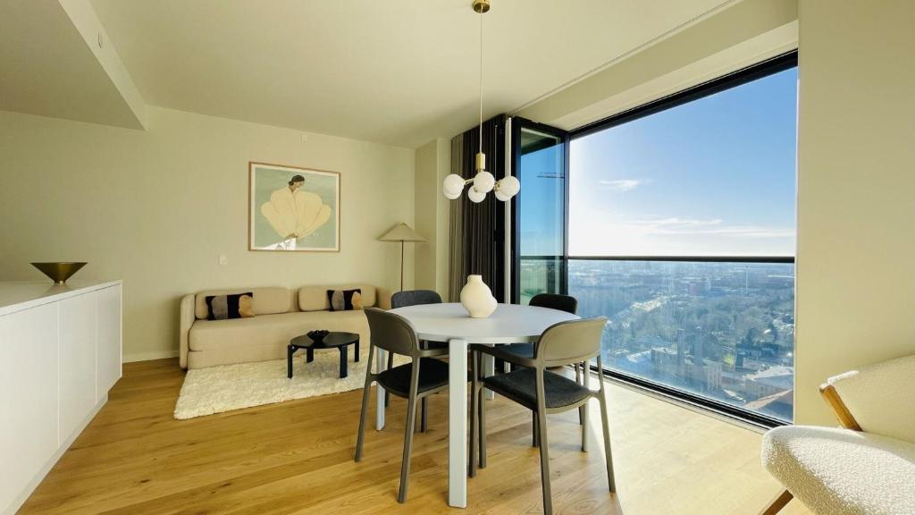 a living room with a table and chairs and a bed at ApartmentInCopenhagen Apartment 1525 in Copenhagen