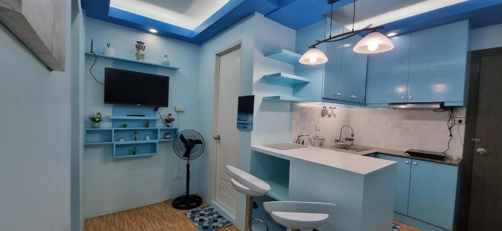 a blue kitchen with a sink and a toilet at Mistow BriaScarlet Condo in Cagayan de Oro