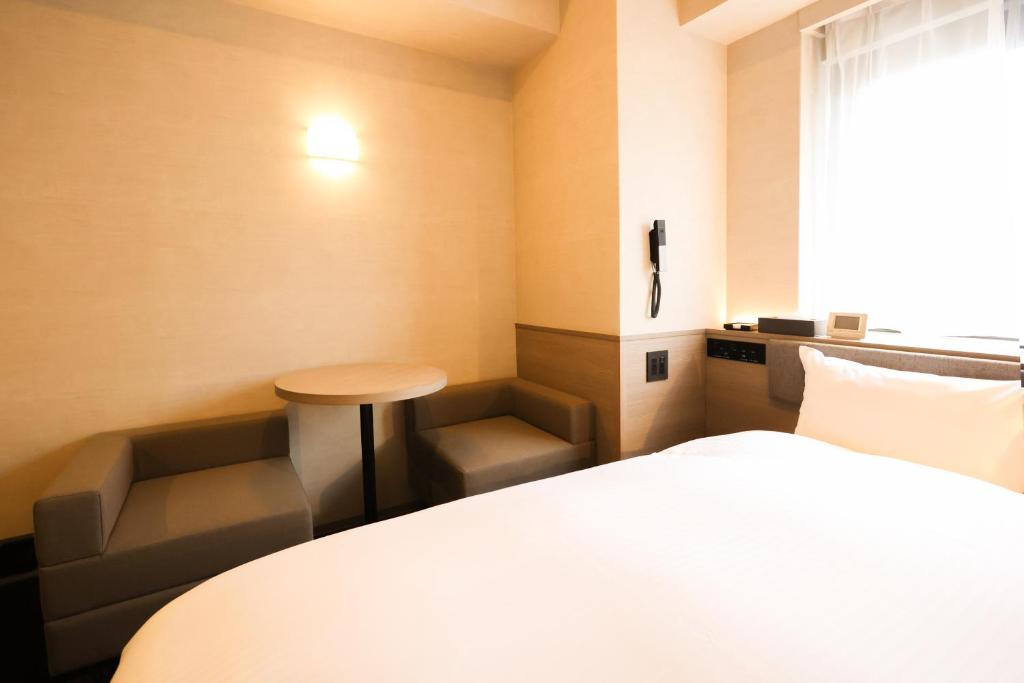 Postel nebo postele na pokoji v ubytování SK HOTEL Kobe Ekimae