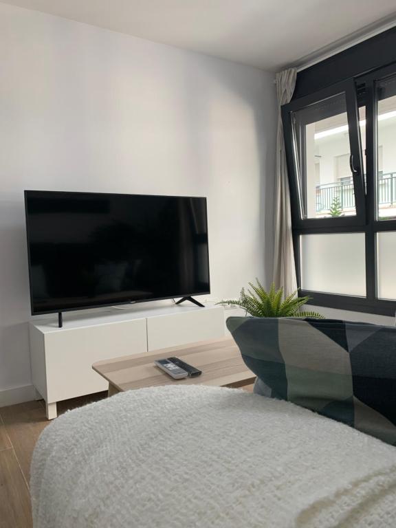 a living room with a large flat screen tv at Apartamento Central D in Algeciras