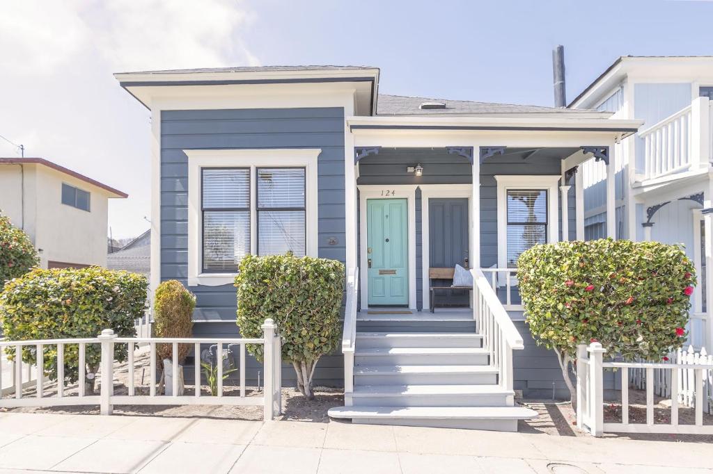 a blue house with a blue door and stairs at 3814 Surf's Up! home in Pacific Grove