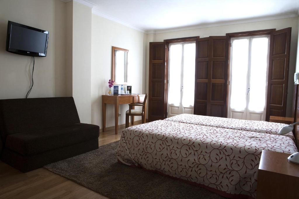 Postel nebo postele na pokoji v ubytování Guesthouse Muralhas do Mino