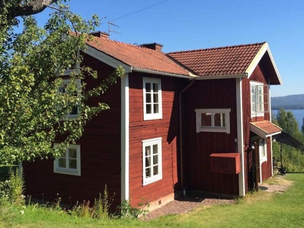 a red house with a red roof at Holiday home SILJANSNÄS in Siljansnäs