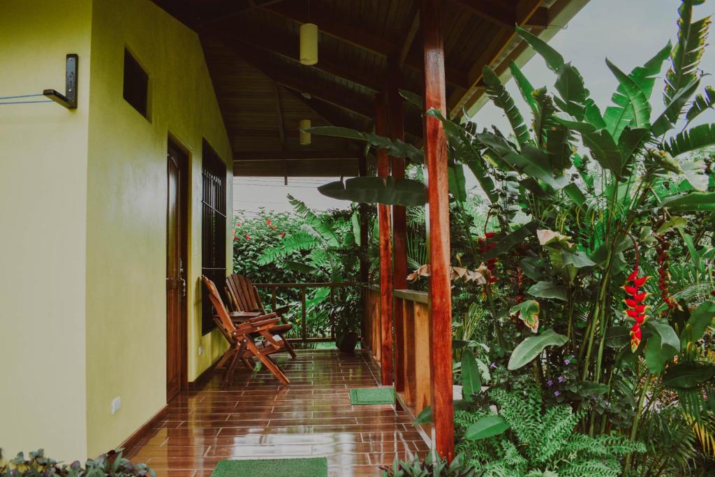 a porch of a house with a chair and plants at Arenal Descanso in Fortuna
