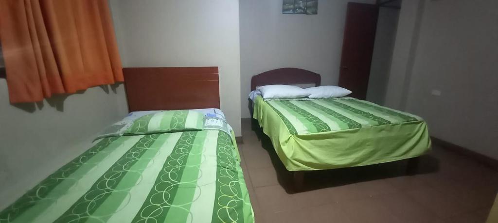 Postel nebo postele na pokoji v ubytování Hostal Aventura