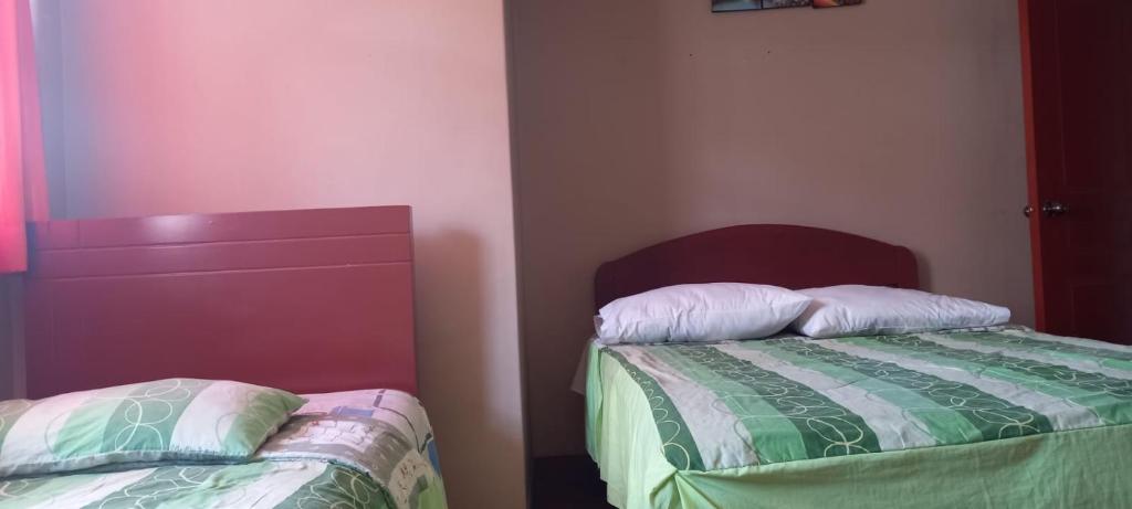 Postel nebo postele na pokoji v ubytování Hostal Aventura