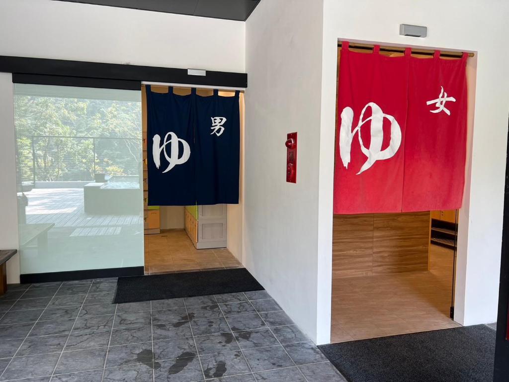 a hallway with two flags on a wall at Tangyue Resort in Tai&#39;an
