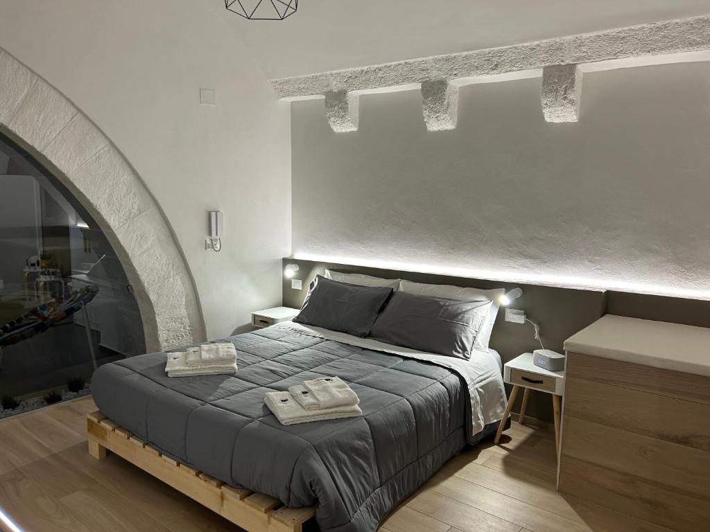 a bedroom with a bed with two towels on it at Archome Luxury Apartment in Brindisi