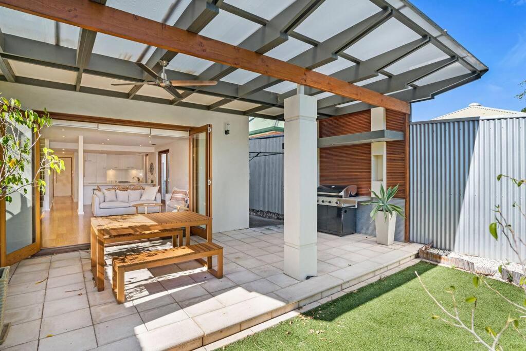 a patio with a pergola and a table at Goodie Goodwood Family Home in Unley