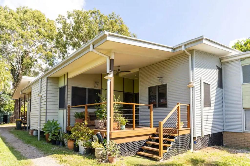 a home with a porch with plants on it at Eagles Nest Two Bed Home Nudgee Beach in Brighton