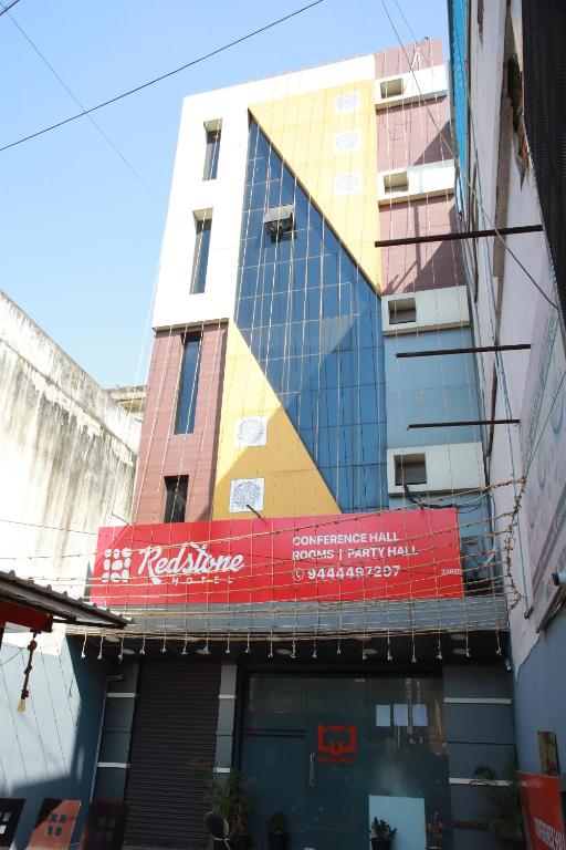 a building with a sign on the side of it at Redstone Hotel - Near US Consulate Nungambakkam in Chennai