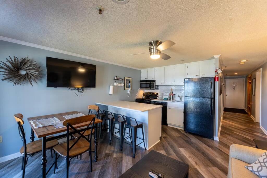 a kitchen and dining room with a table and a refrigerator at ML204 2BR/2BA Bright & Airy Lift View WiFi EZ Park in Dunmore