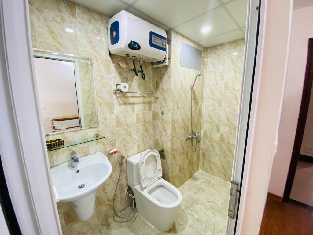 y baño con lavabo, aseo y ducha. en Sky Halong Apartment en Ha Long
