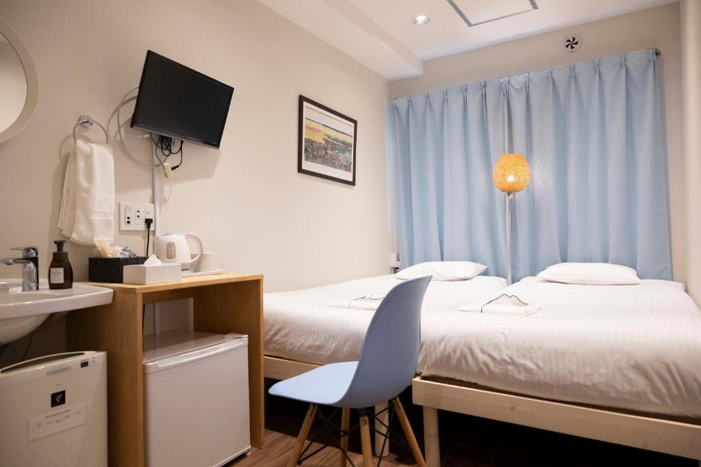 Postel nebo postele na pokoji v ubytování ELE Hotel Ginza East