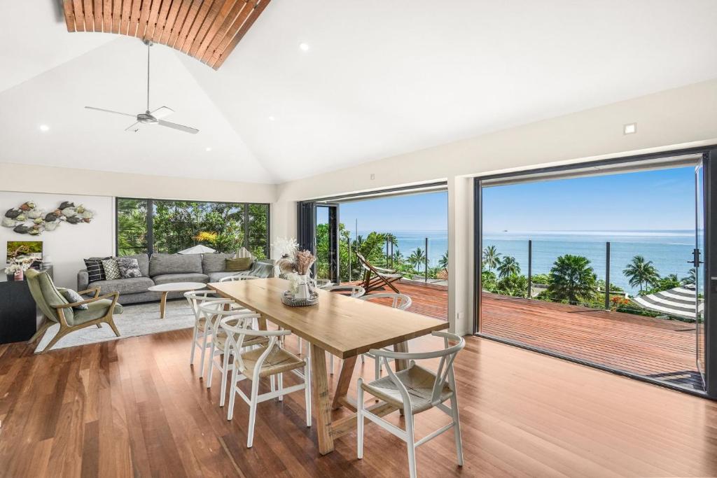 a dining room with a view of the ocean at Belle Escapes Trinity Blue Oceanview Home in Trinity Beach