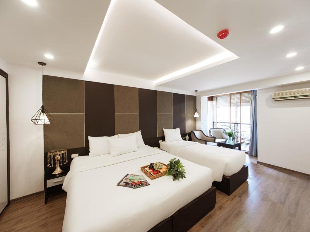 Postel nebo postele na pokoji v ubytování Keypad Hotel - 24 Hang Ga