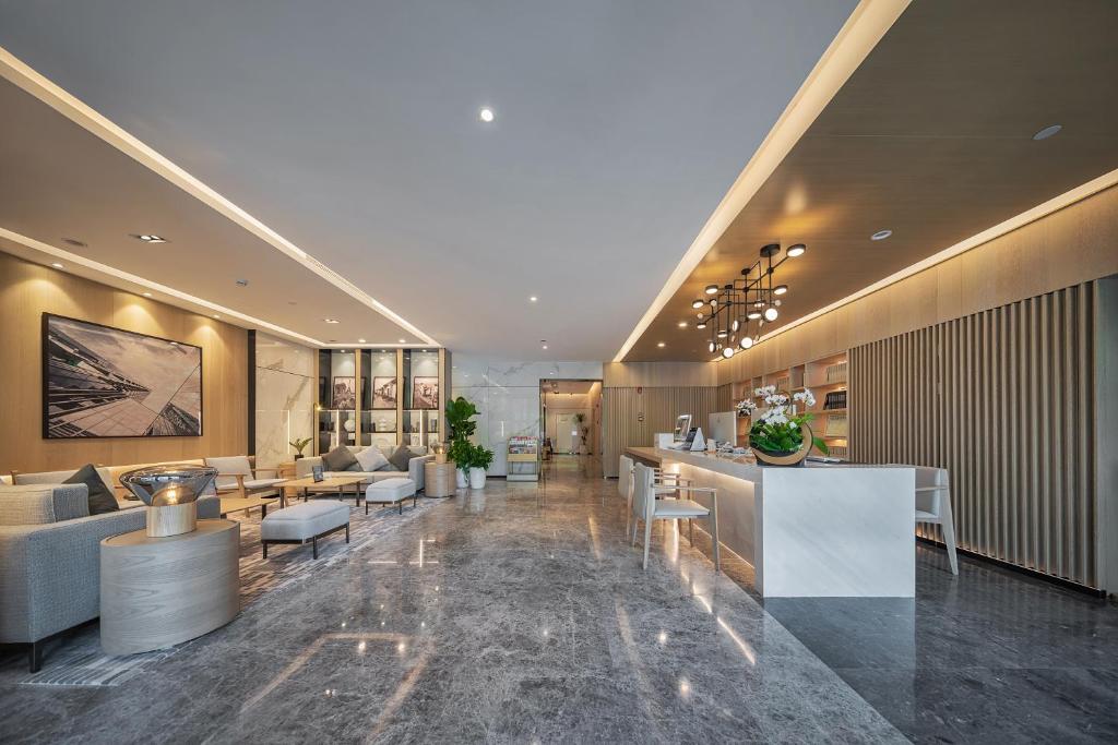 a lobby of a hotel with couches and tables at CM Serviced Apartment Shenzhen Dongmen in Shenzhen