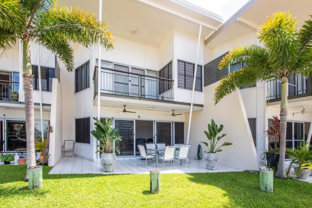 an exterior view of a building with palm trees at Magnetic Docks Townhouse 5 in Nelly Bay