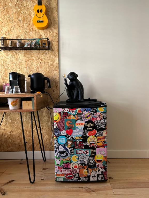 um gato preto sentado em cima de um refrigerador em Monkey Tree Stay em Schiedam