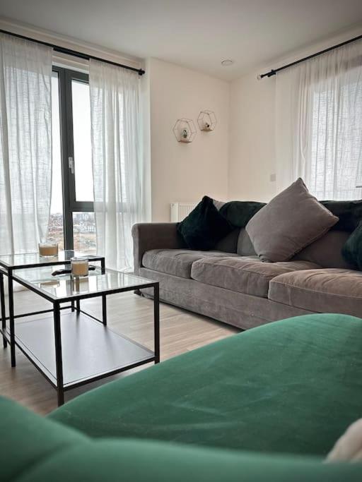 a living room with a couch and a coffee table at NEW Modern 2 Bedroom Apartment! in Dagenham