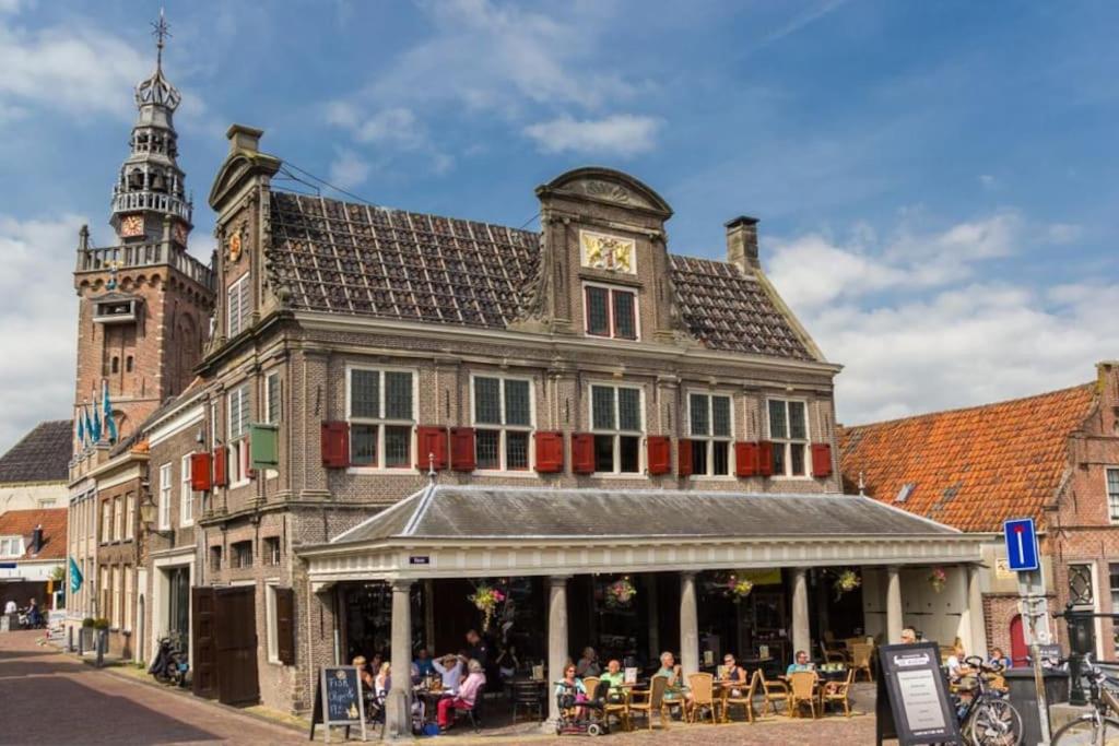 a building with a clock tower on top of it at Modern, brand new houseboat near Amsterdam in Monnickendam