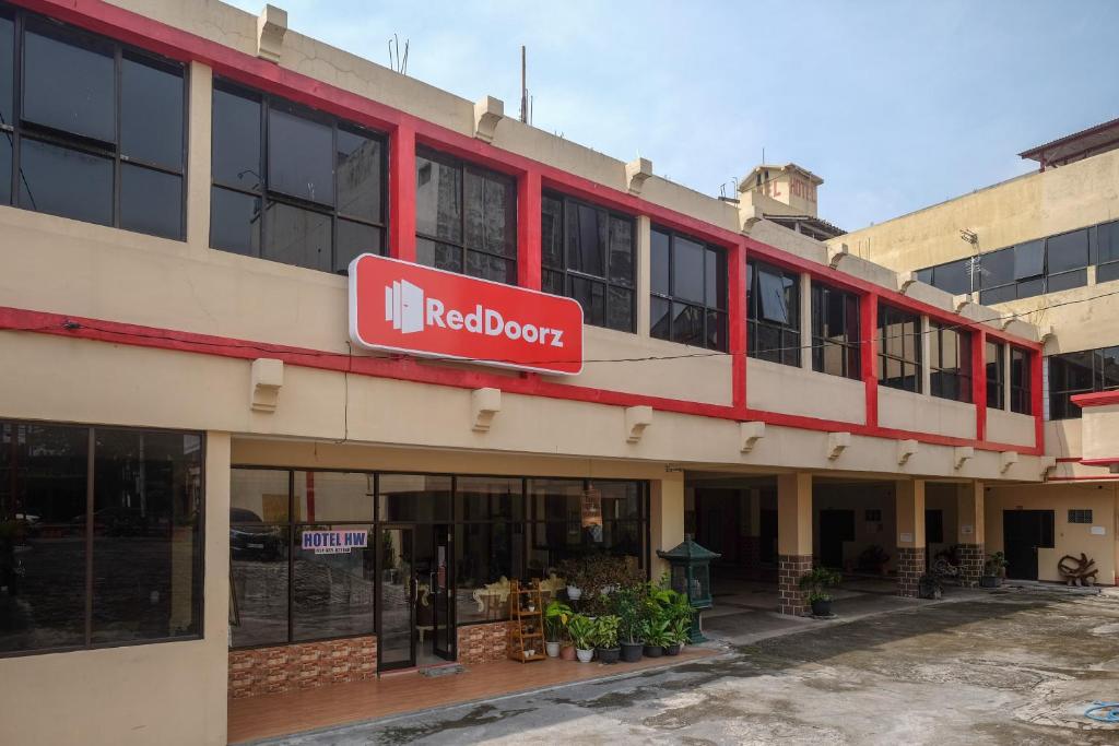 a red depot sign on the side of a building at RedDoorz at H&W Hotel Solo in Solo