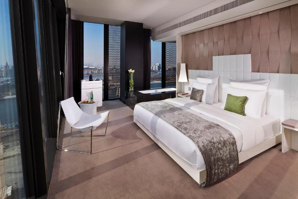 a bedroom with a large bed and a large window at Melia Vienna in Vienna