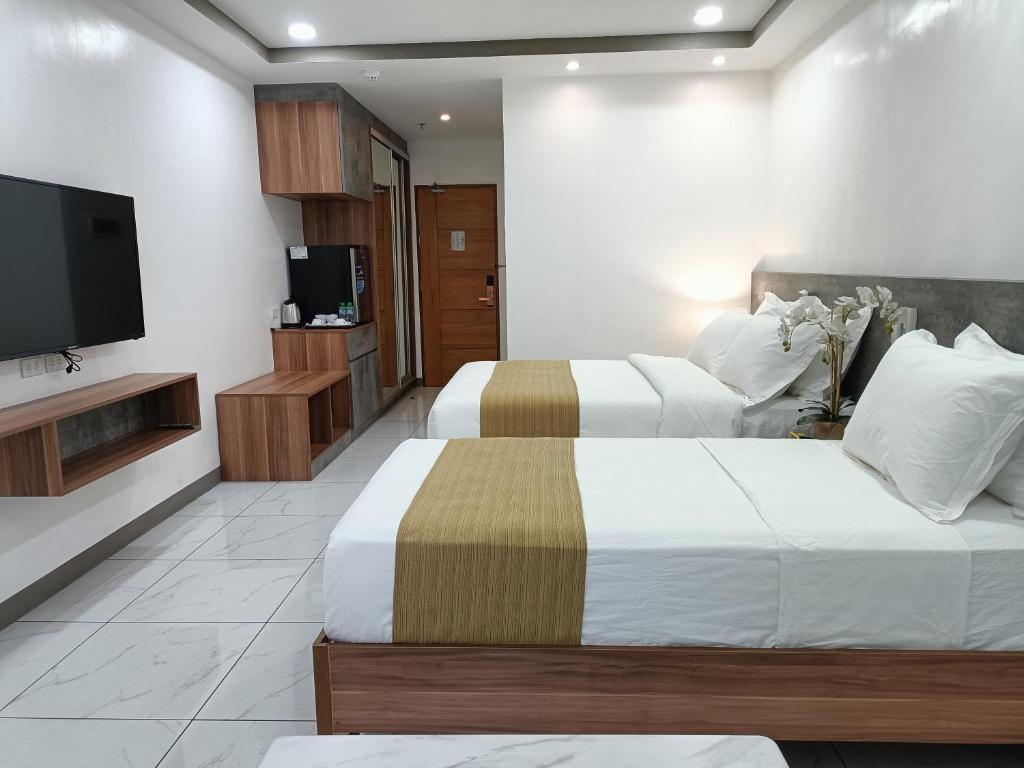 Postel nebo postele na pokoji v ubytování Rosh Hotel