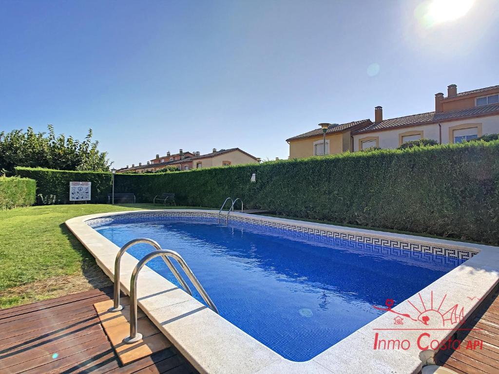 a swimming pool in the backyard of a house at La Vela Estartit Rental in L'Estartit