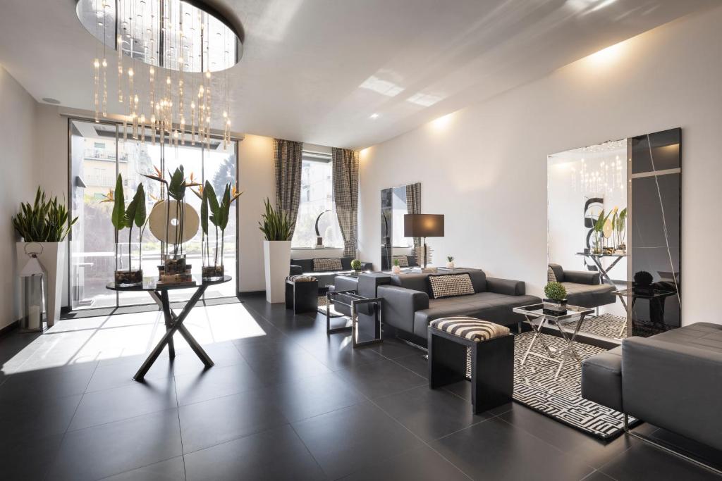 a living room with a couch and chairs and a table at LHP Napoli Palace & SPA in Naples