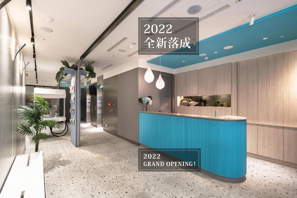 a lobby of a dental office with a blue counter at Comma Boutique Hotel in Taipei