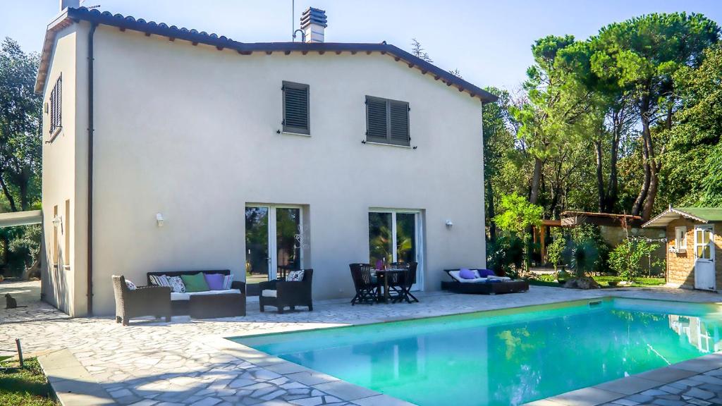 a white house with a swimming pool in front of it at Casa di Palì 8, Emma Villas in Ripe