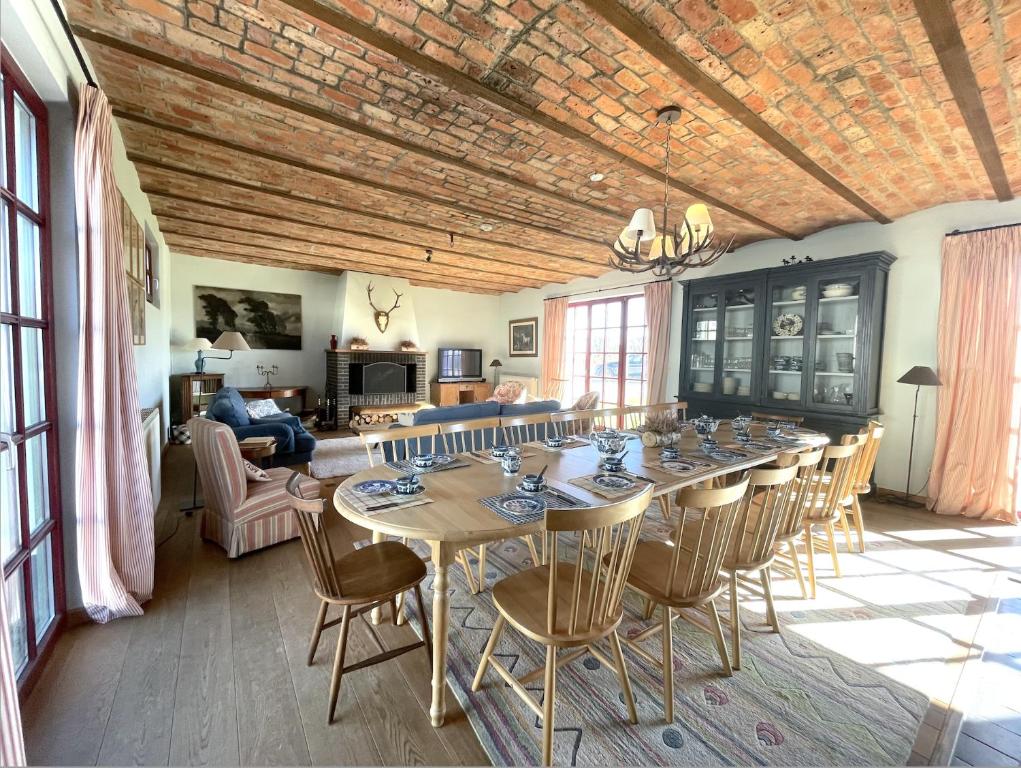 a dining room with a long table and chairs at La ferme du Bailly in Couvin