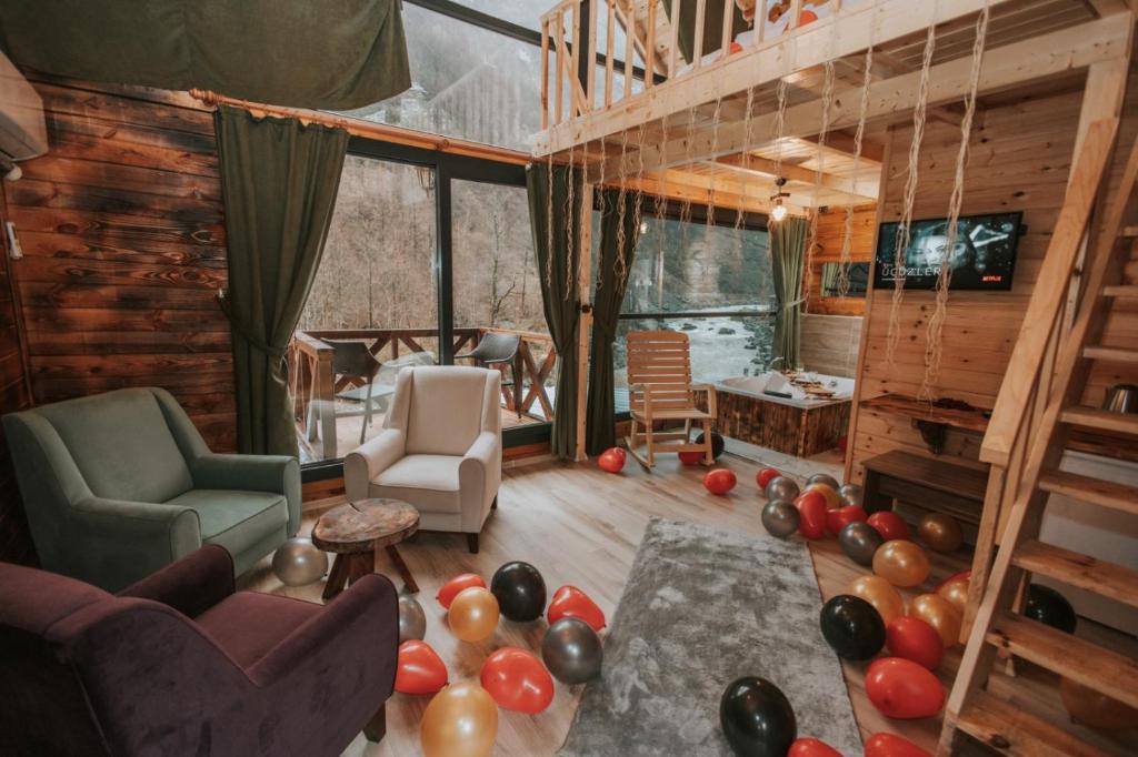 a living room with a bunch of balloons on the floor at Pınar Suit Bungalow in Ardeşen