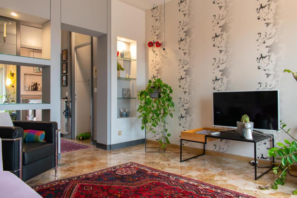 sala de estar con TV de pantalla plana en la pared en Caserma Ederle Budget Apartment x3, en Vicenza