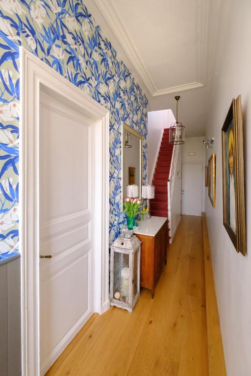 a hallway with blue and white wallpaper at Collier's BnB in Bruges