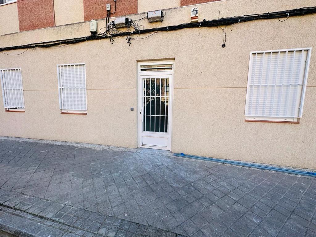 a building with a white door and windows at HOSPEDAJE CUATRO VIENTOS in Madrid