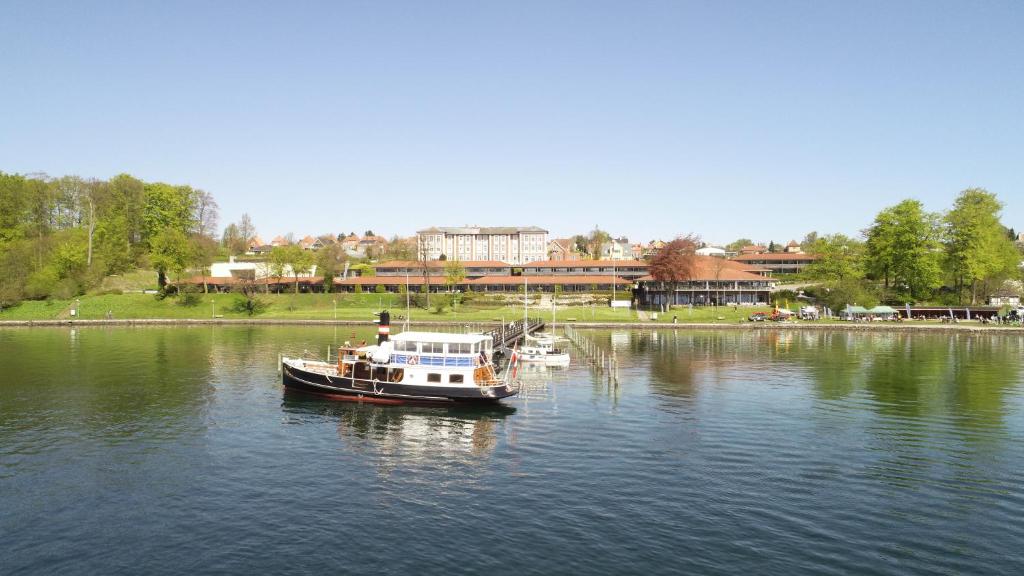 a boat floating on the water in a lake at Hotel Christiansminde in Svendborg