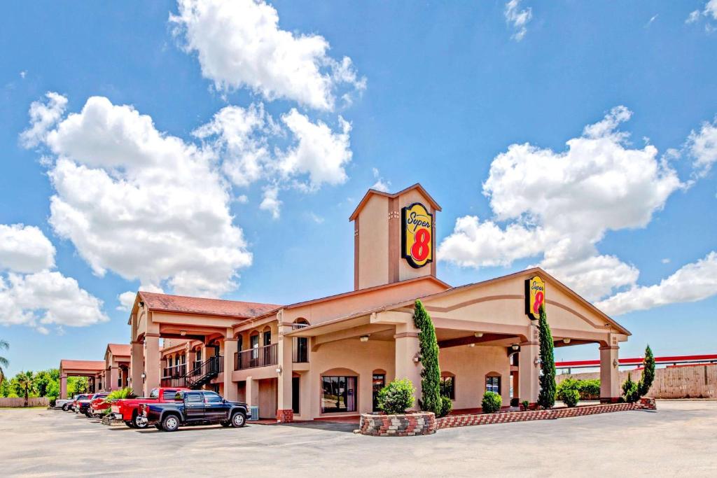 a fast food restaurant with cars parked in a parking lot at Super 8 by Wyndham Baytown/Mont Belvieu in Eldon