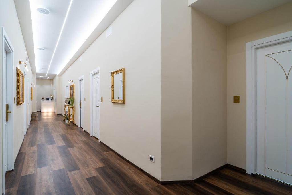 an empty hallway with white walls and wood floors at Correnti Boutique Hotel Gold in Sanremo
