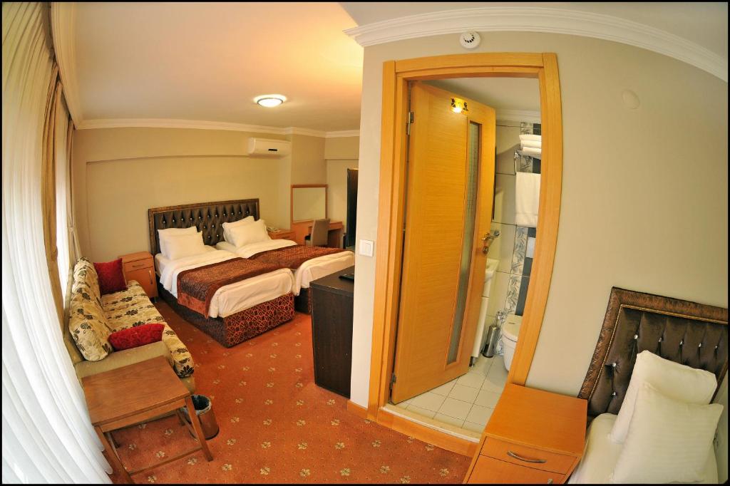 a hotel room with a bed and a bathroom at Palace Point Hotel in Istanbul