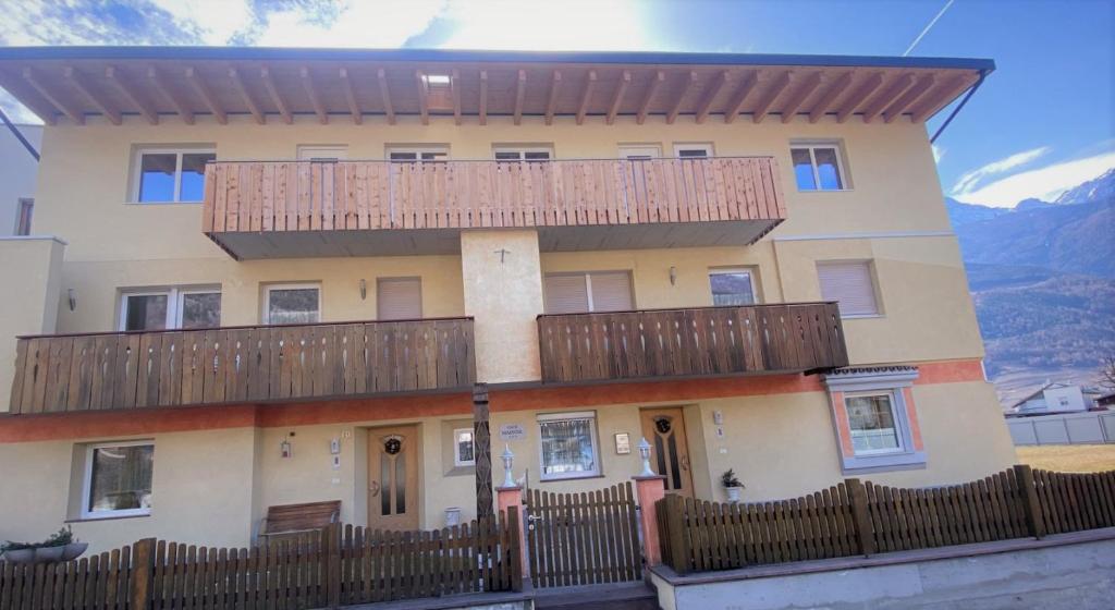 a large house with a balcony on top of it at Haus Mairösl in Silandro