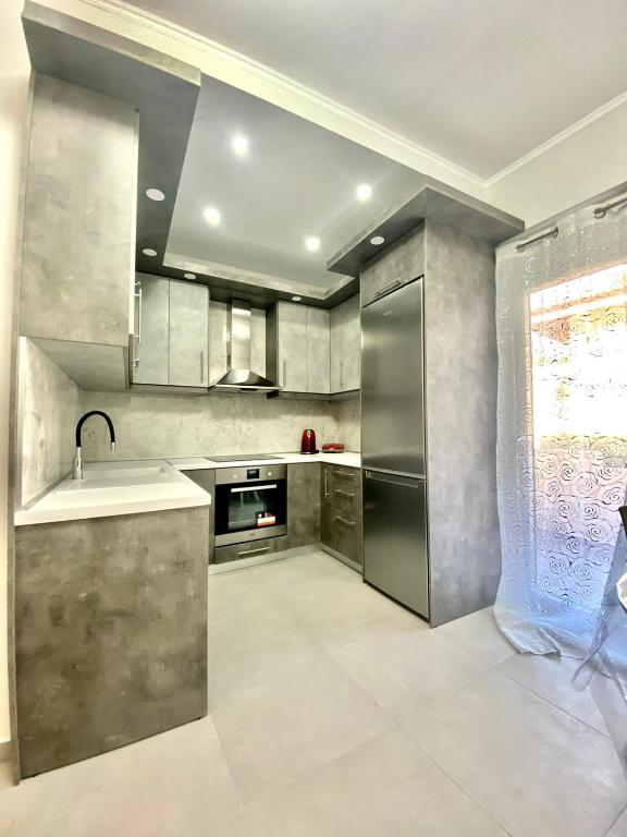 a kitchen with stainless steel appliances and a sink at Σουίτα Αλέξανδρος in Pefkochori