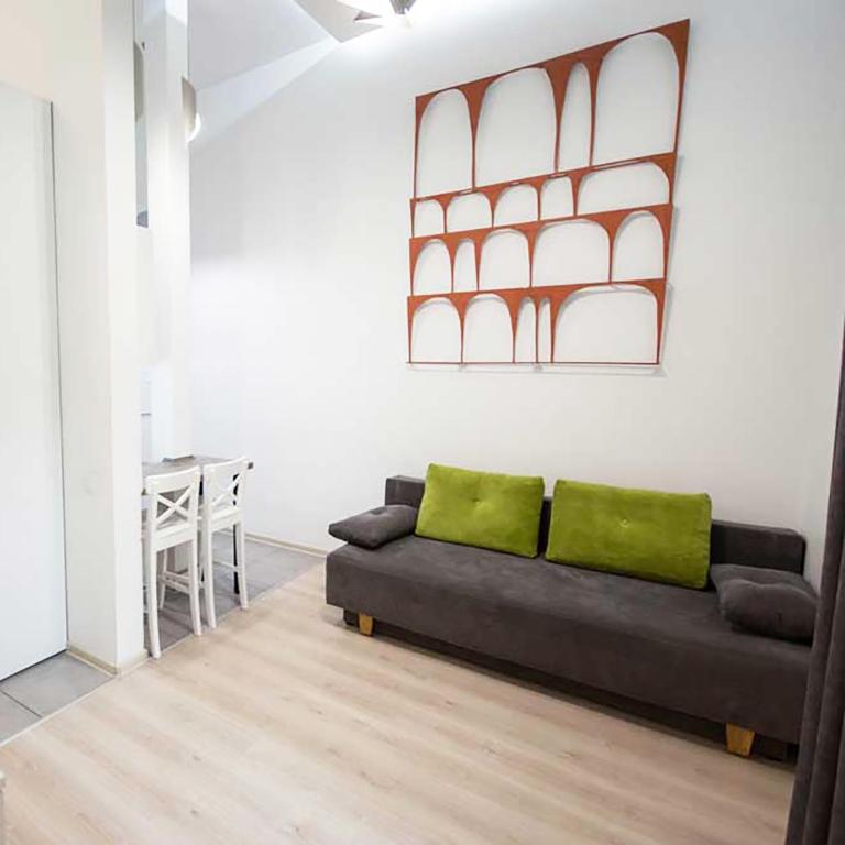a living room with a couch and a table at Kyiv White Apartment in Kyiv