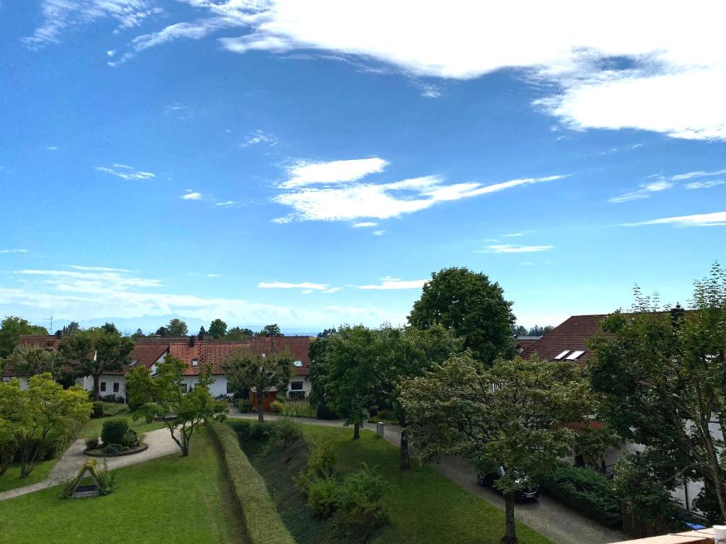 a view of a park with trees and a blue sky at Auszeit in Immenstaad am Bodensee